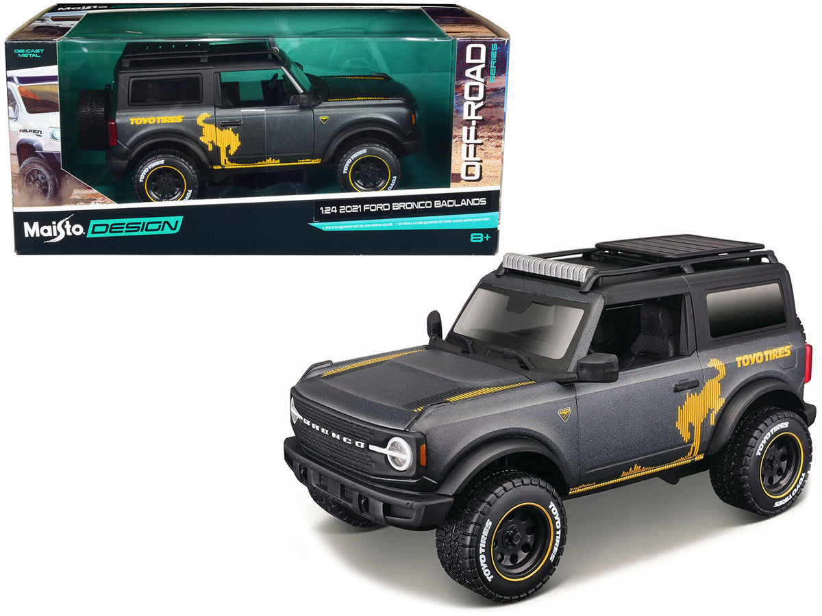 2021 Ford Bronco Badlands Dark Gray Metallic with Gold Graphics and Roof Rack "Off-Road" "Maisto Design" Series 1/24 Diecast Model Car by Maisto LuxuryLifeWay Online Store