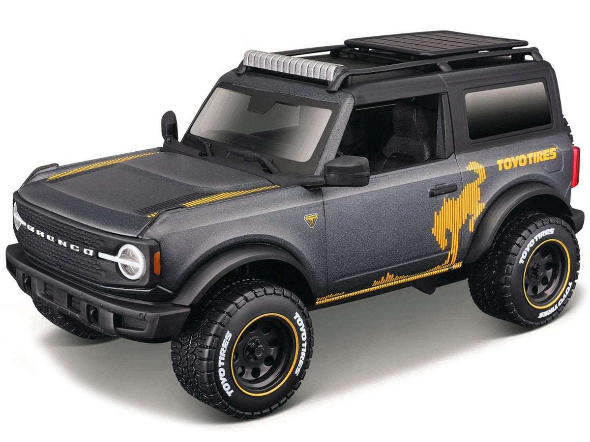 2021 Ford Bronco Badlands Dark Gray Metallic with Gold Graphics and Roof Rack "Off-Road" "Maisto Design" Series 1/24 Diecast Model Car by Maisto LuxuryLifeWay Online Store