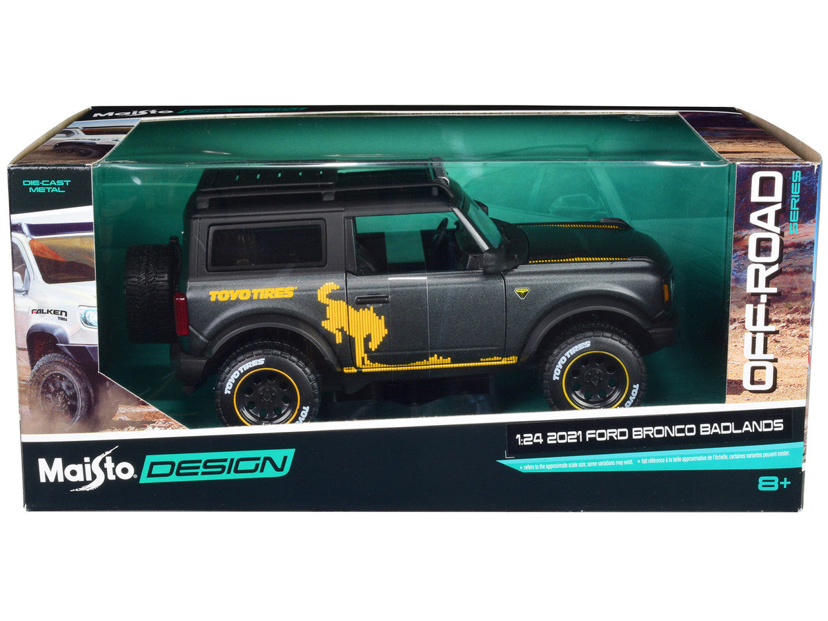 2021 Ford Bronco Badlands Dark Gray Metallic with Gold Graphics and Roof Rack "Off-Road" "Maisto Design" Series 1/24 Diecast Model Car by Maisto LuxuryLifeWay Online Store