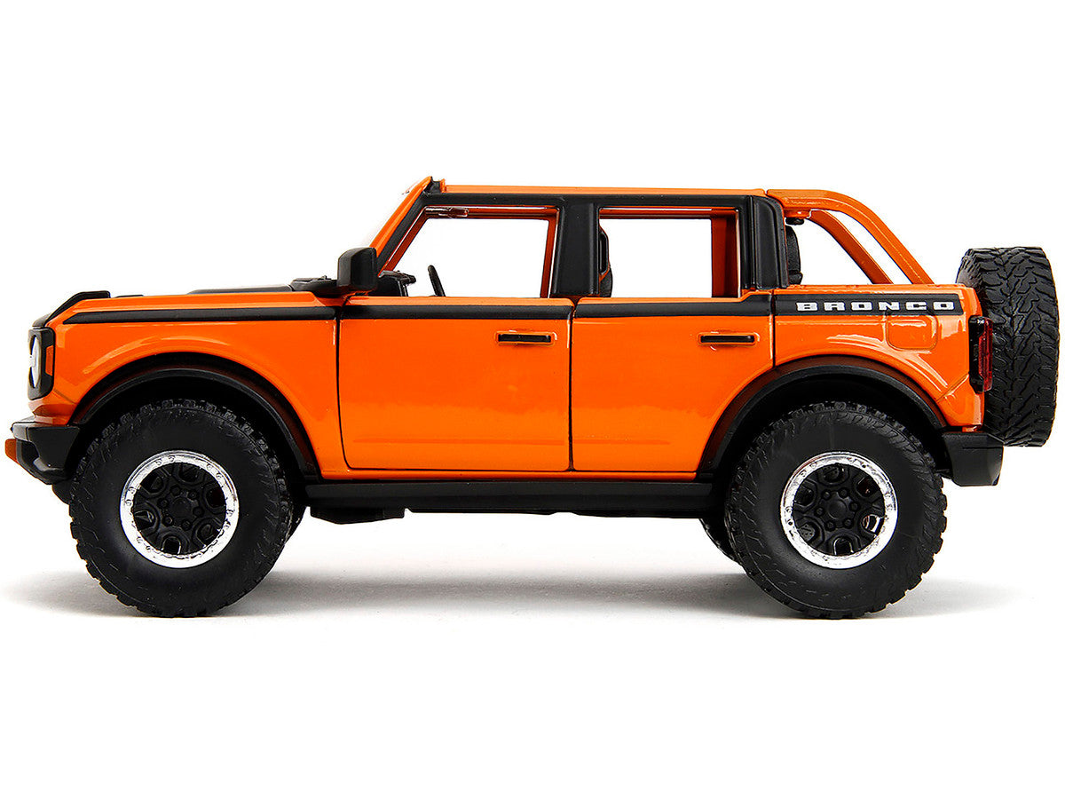 2021 Ford Bronco Open-Top Orange with Black Stripes and Hood with Extra Wheels "Just Trucks" Series 1/24 Diecast Model Car by Jada LuxuryLifeWay Online Store