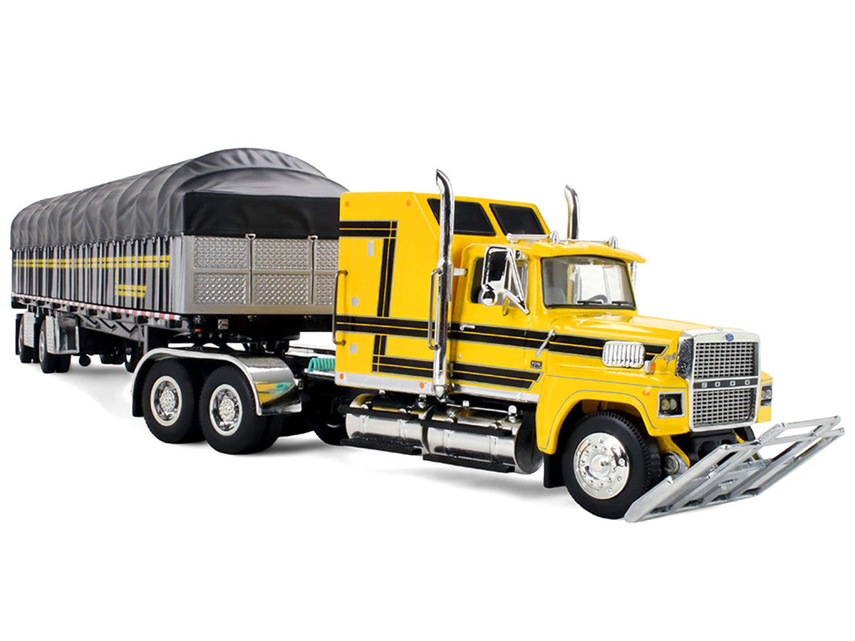 Ford LTL 9000 with 60" Aerodyne Sleeper and 53' Wilson Roadbrute Flatbed Trailer with Covered Wagon Yellow with Black Stripes 1/64 Diecast Model by DCP/First Gear LuxuryLifeWay Online Store