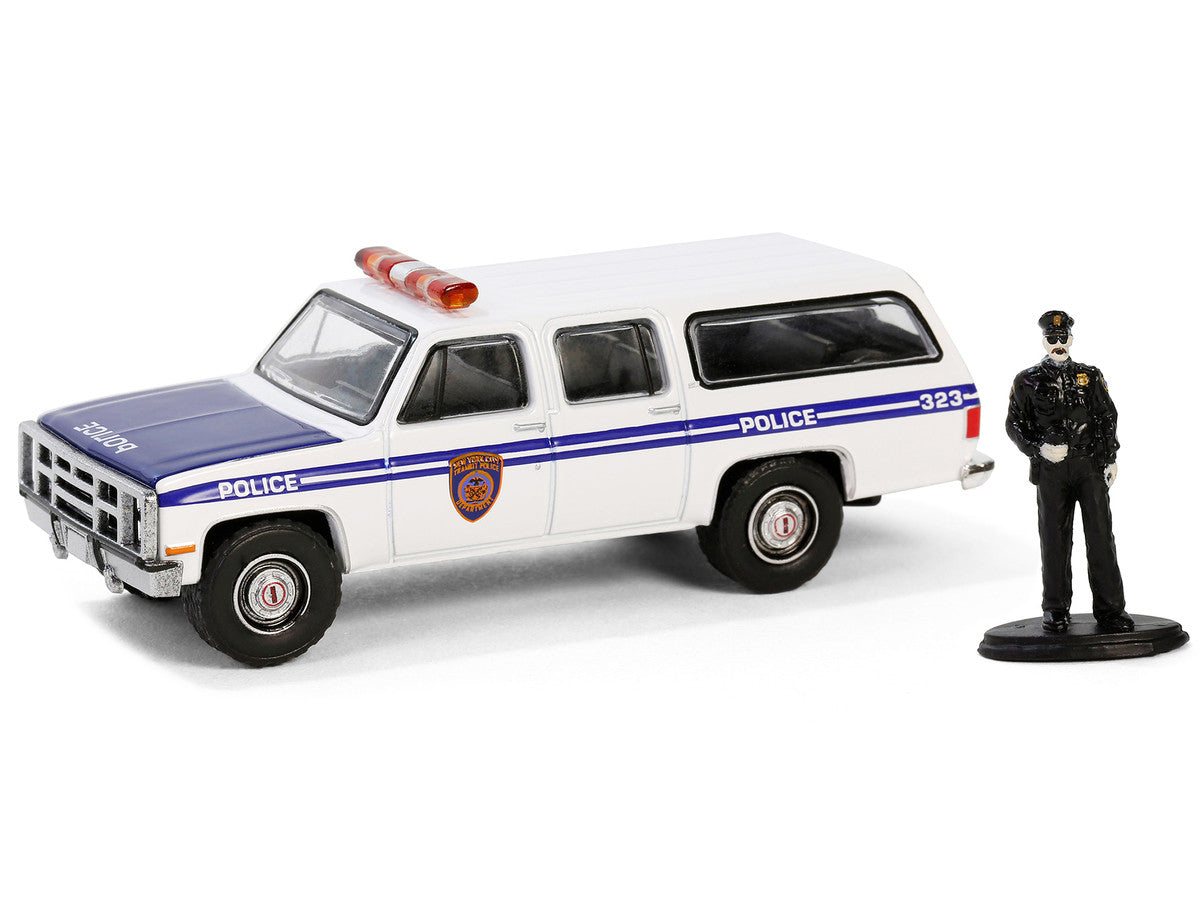 1985 GMC Suburban 2500 "New York City Transit Police Department" White with Blue Stripes and Police Officer Figure "The Hobby Shop" Series 16 1/64 Diecast Model Car by Greenlight LuxuryLifeWay Online Store